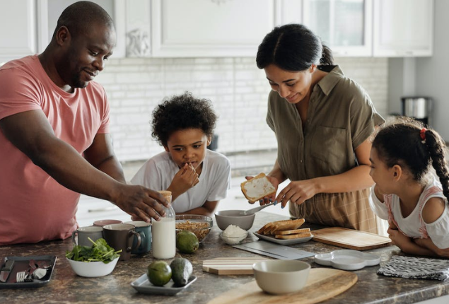 family-of-four-cooking-together